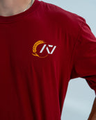 Red unisex over-fit shirt with a logo on a light gray background