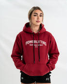 Female wearing a red 'Powerlifting' Bar Grip hoodie on a white background