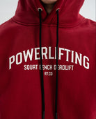 Red Bar Grip hoodie with 'POWERLIFTING' text on a plain background