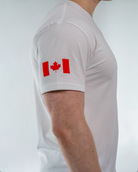 White t-shirt with a red Canadian flag design on a plain background