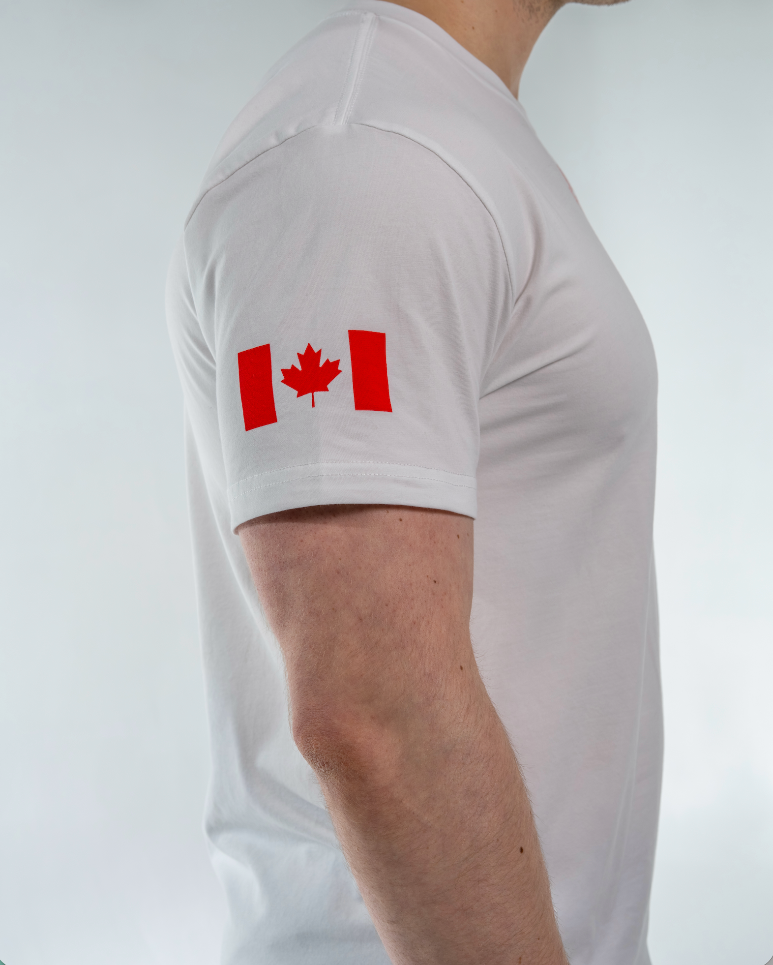White t-shirt with a red Canadian flag design on a plain background