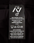 Clothing label with text and symbols on a black background