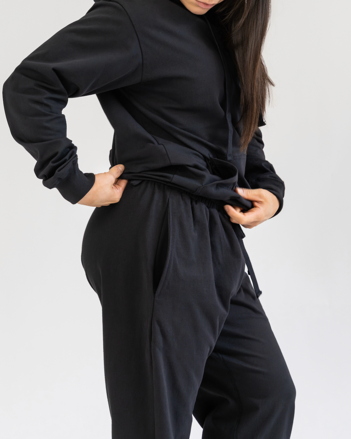 Person wearing a black outfit on a plain background