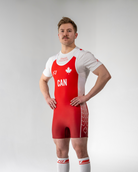 Person wearing a red and white powerlifting singlet with 'CAN' and a maple leaf on a plain background