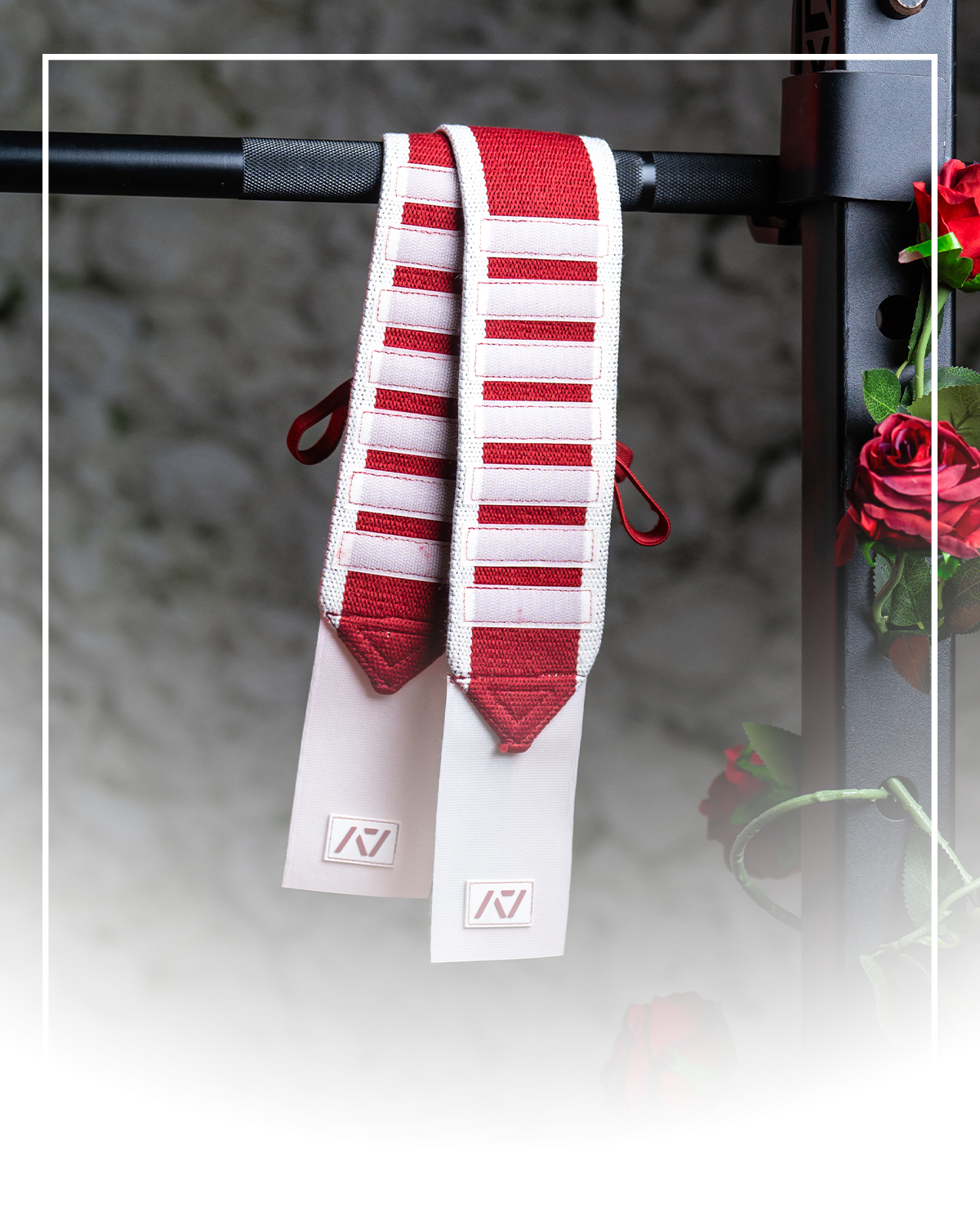 Red and white wrist wraps over a barbell
