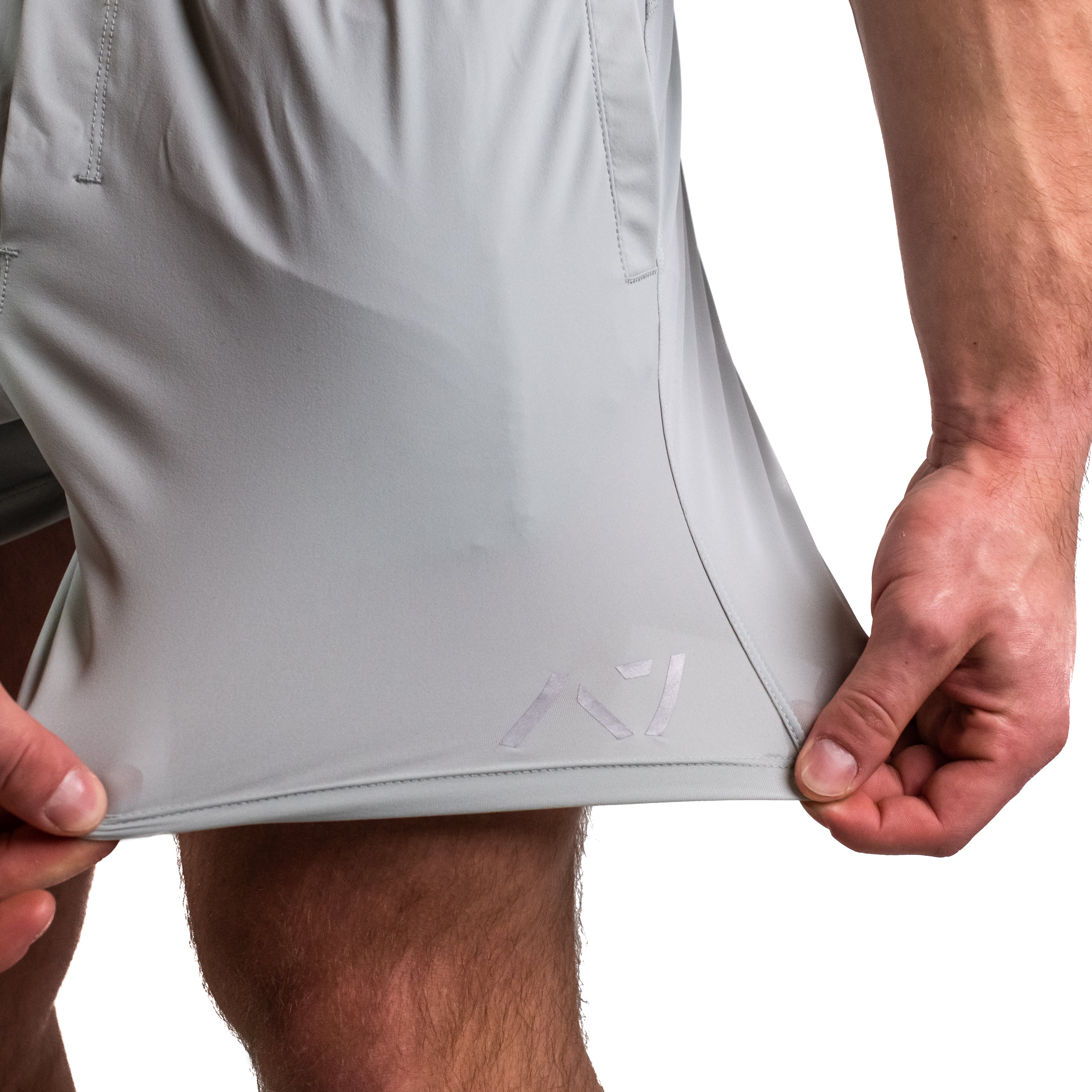 Close-up of 360-degree stretch fabric on Light Gray 360Go KWD Shorts for freedom of movement during training.