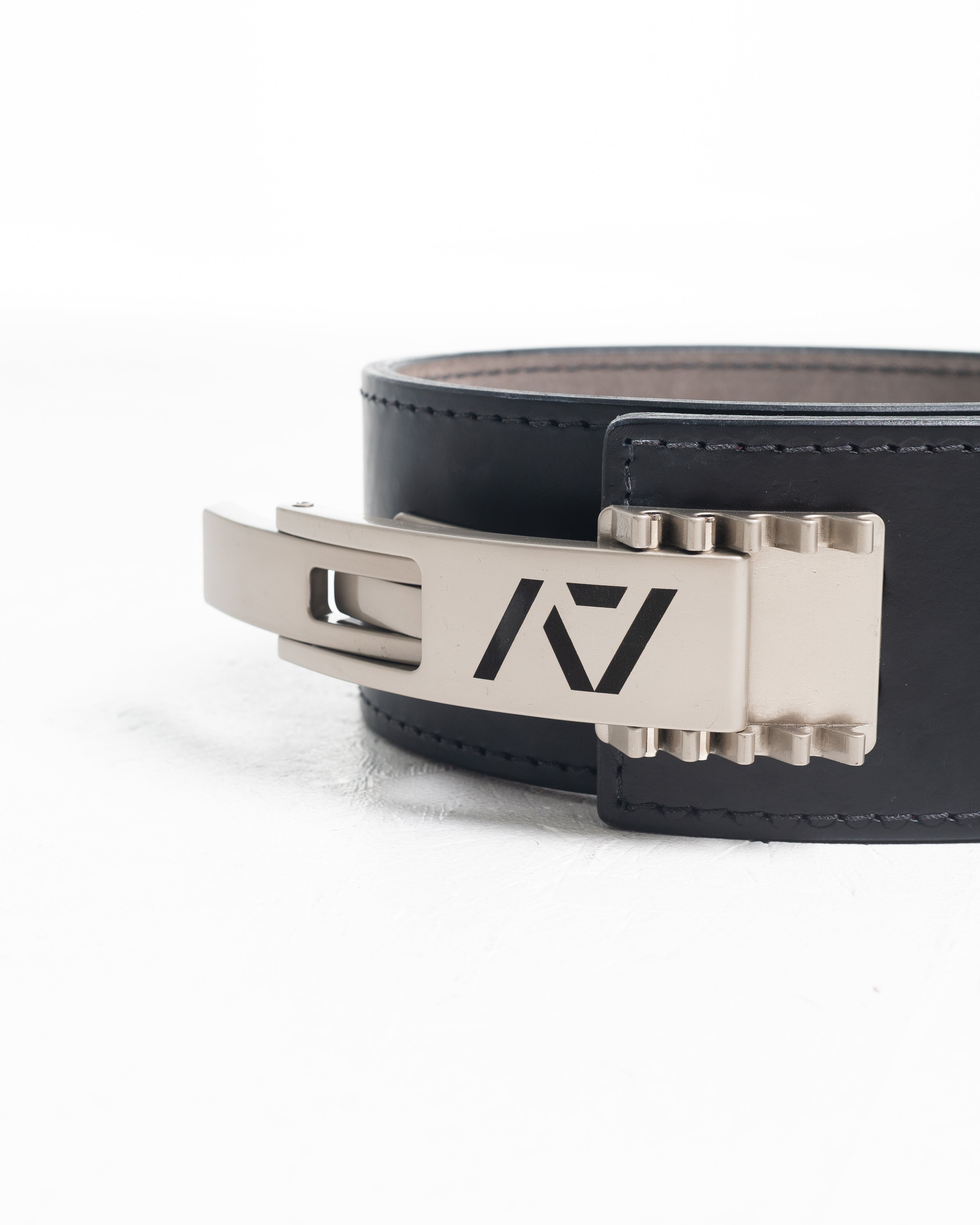 Close up of A7 PAL Buckle in silver mounted on a leather lifting belt, showing compatibility and adjustable fit.